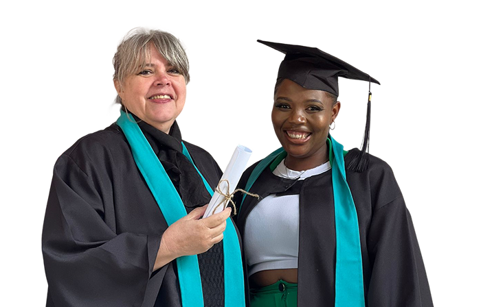 Two women in graduation gowns smiling, one holding a rolled-up certificate.